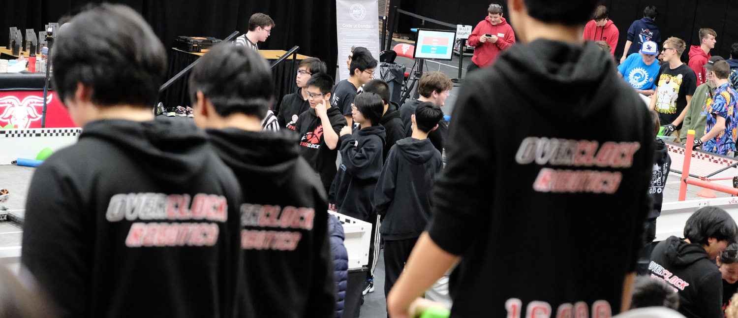 Overclock Robotics team members competing at a VEX V5 robotics tournament